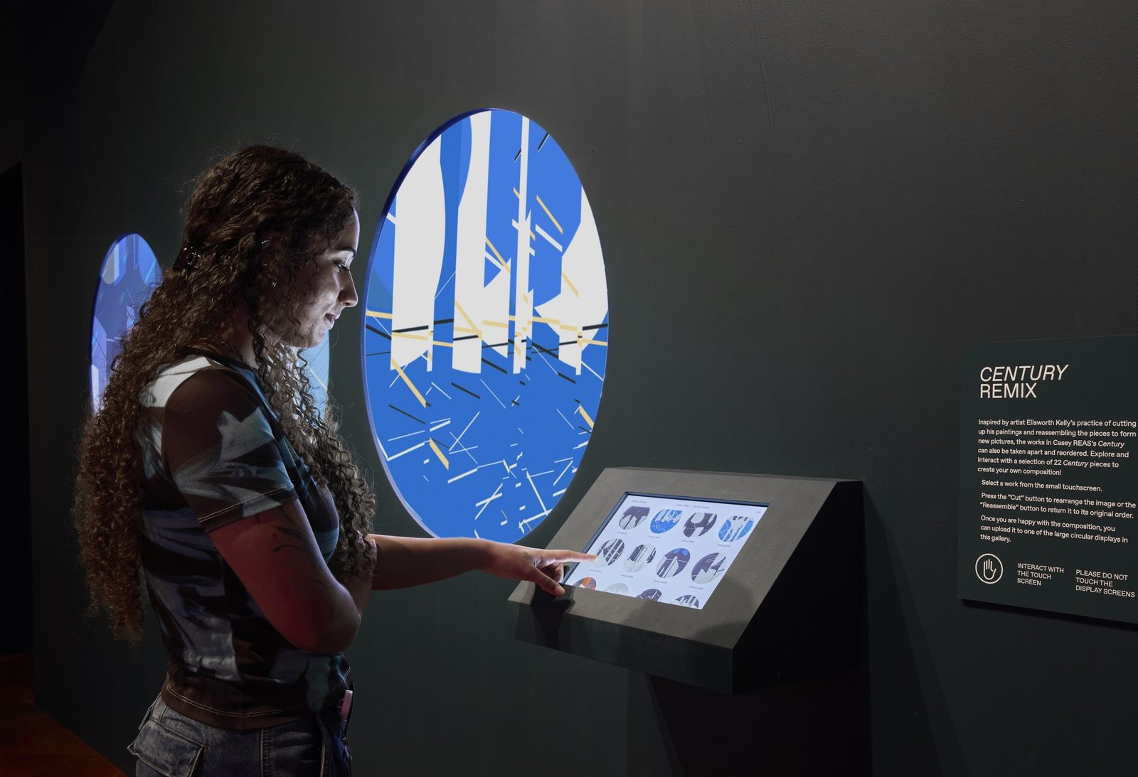 Visitor using the Century Remix touchscreen kiosk