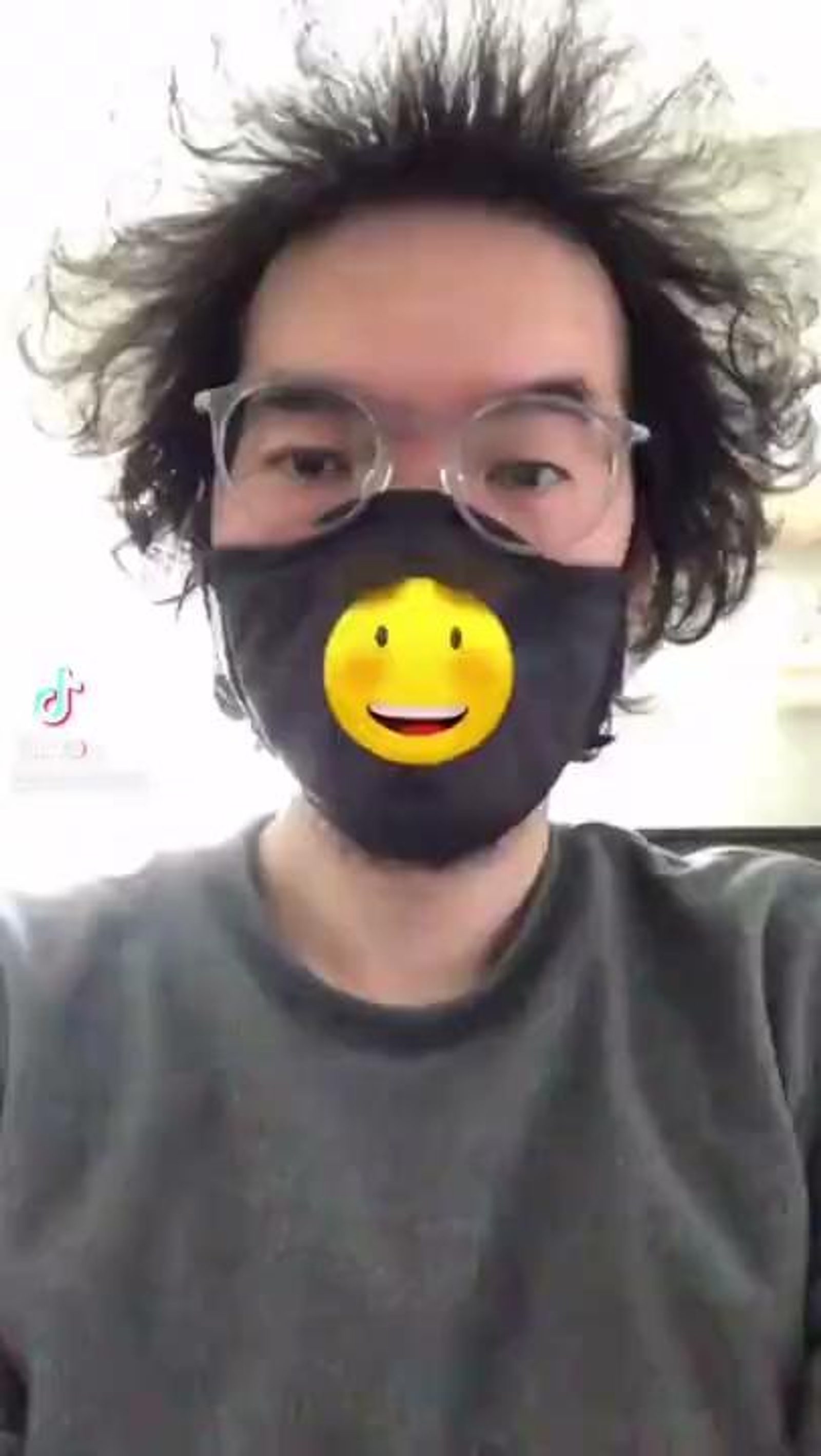 Emoji face-mask effect rendered on a cloth mask